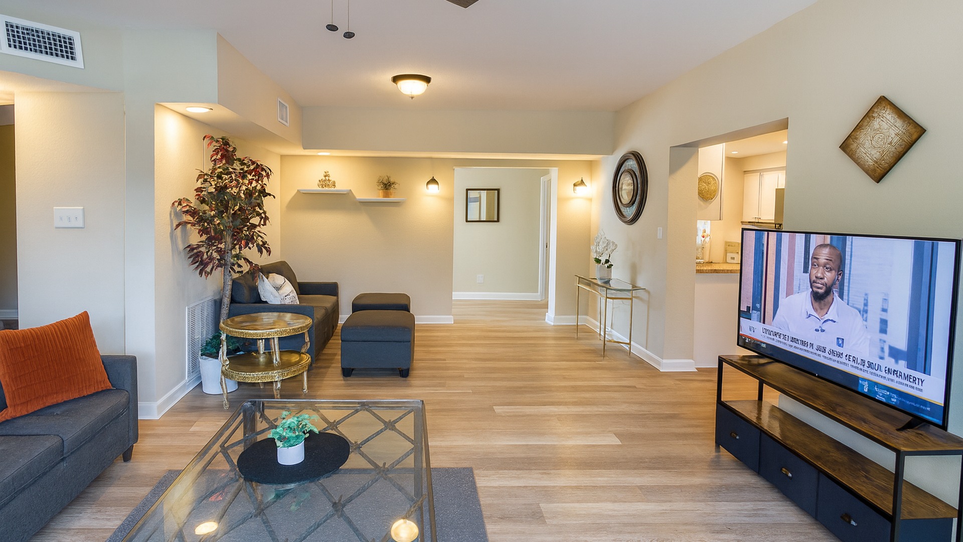 Open-concept living room with stylish coastal décor, smart TV and comfy seating—perfect for relaxing after exploring Madeira Beach and John's Pass from our 5-bed midterm rental in Seminole.