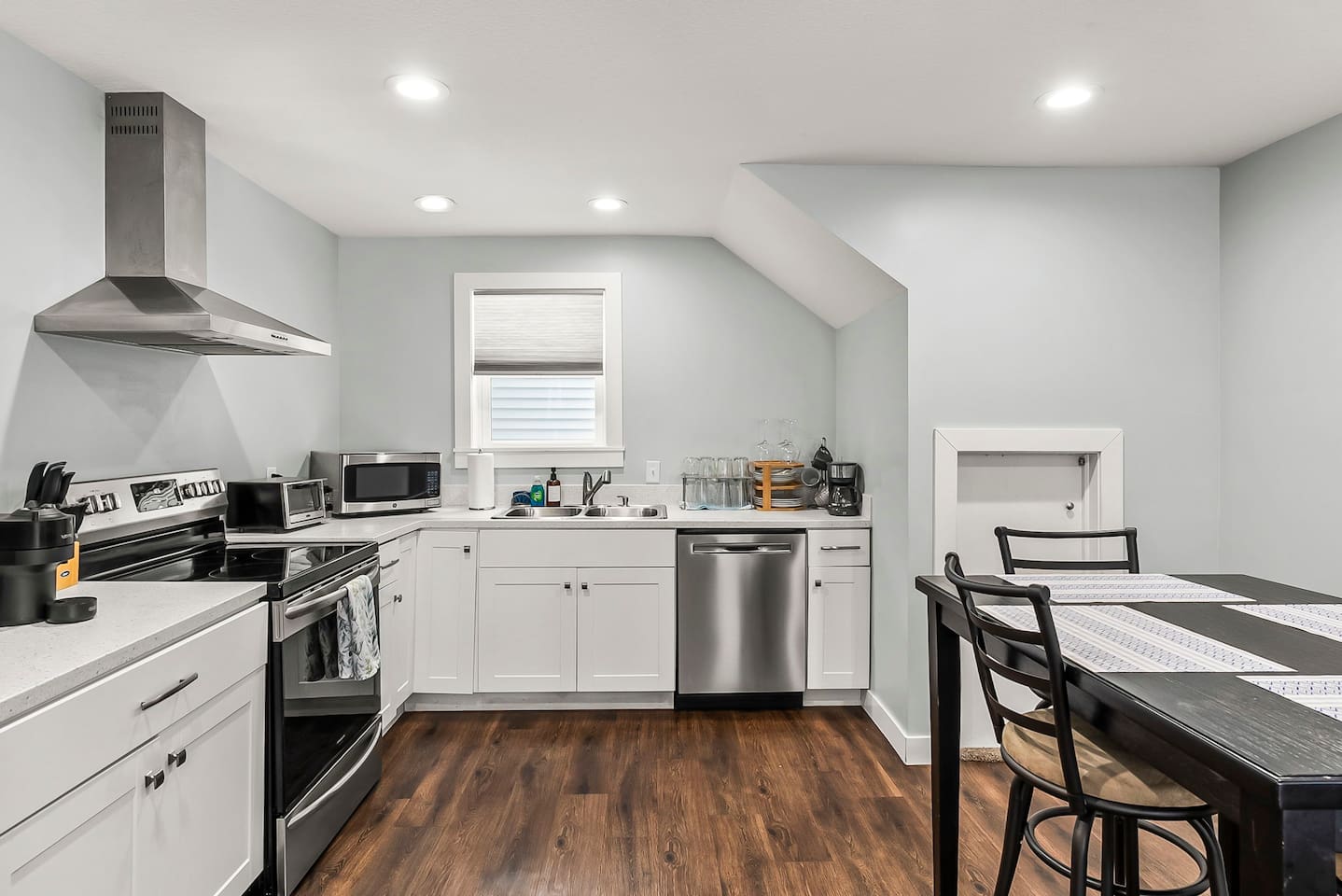 Fully equipped kitchen with all-new stainless steel appliances, modern cabinetry, and bright recessed lighting for easy home cooking.