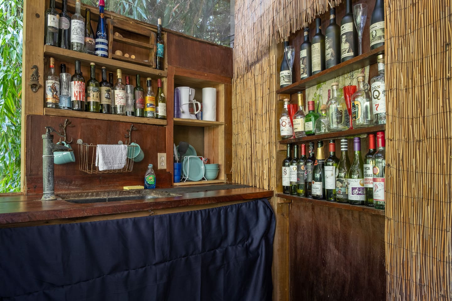 mini kitchen with fridge, microwave, hot plate - AND souvenir bottles from former guests.