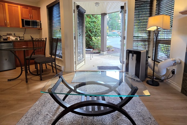 Double glass doors opening to Covered patio with outdoor seating in Unit B.