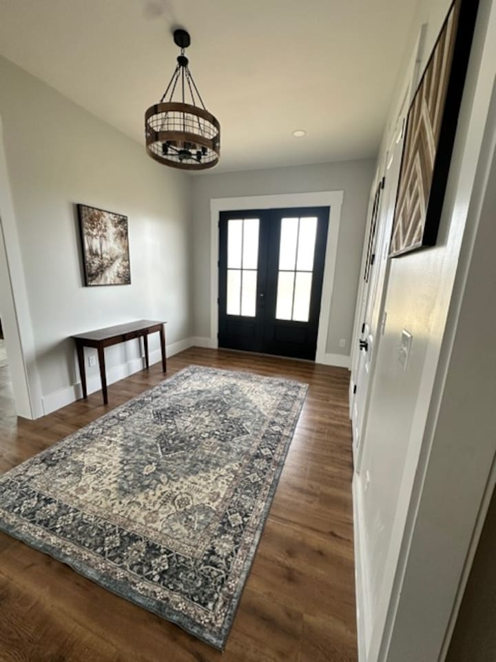 Welcome! Our large double front doors open toward the grand staircase and open living room/kitchen area, with the library/music room on the right when you enter. 