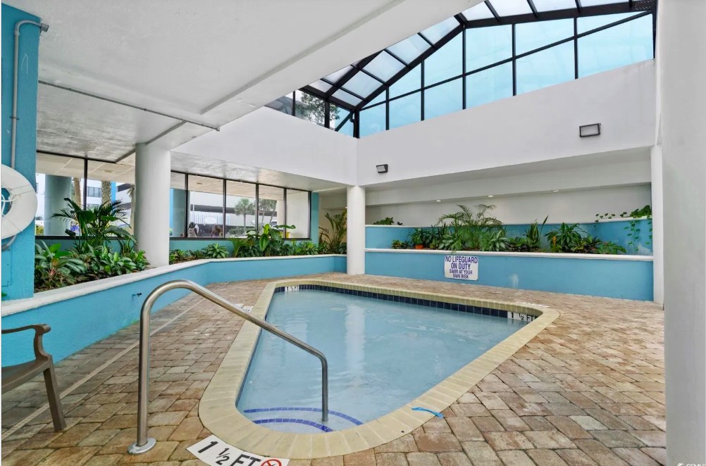 Behold the breathtaking view, where the azure waters of the pool seamlessly blend with the vast expanse of the ocean, creating a true seaside paradise.
