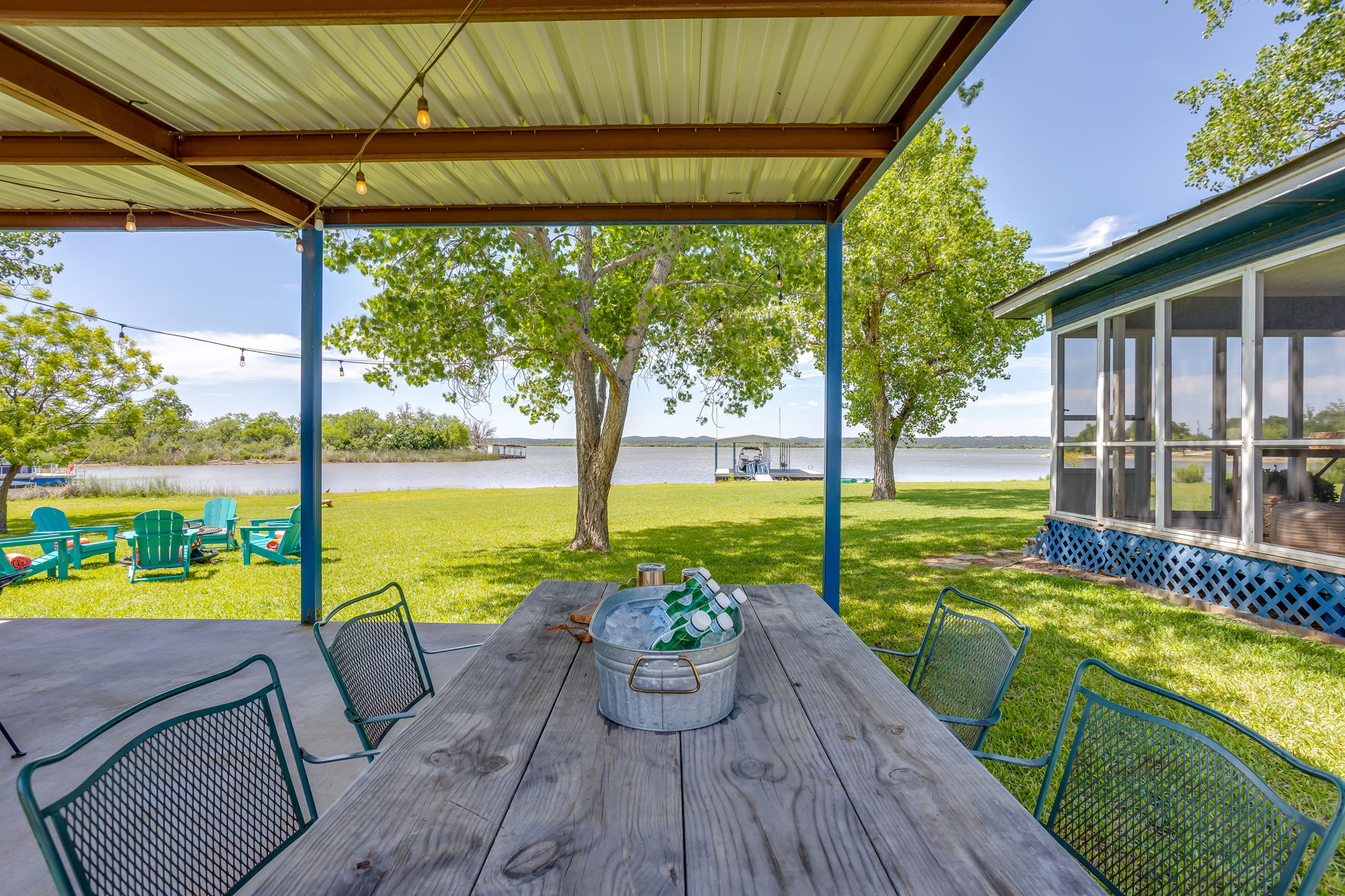 Outdoor covered patio with gas grill, charcoal grill and lots of seating