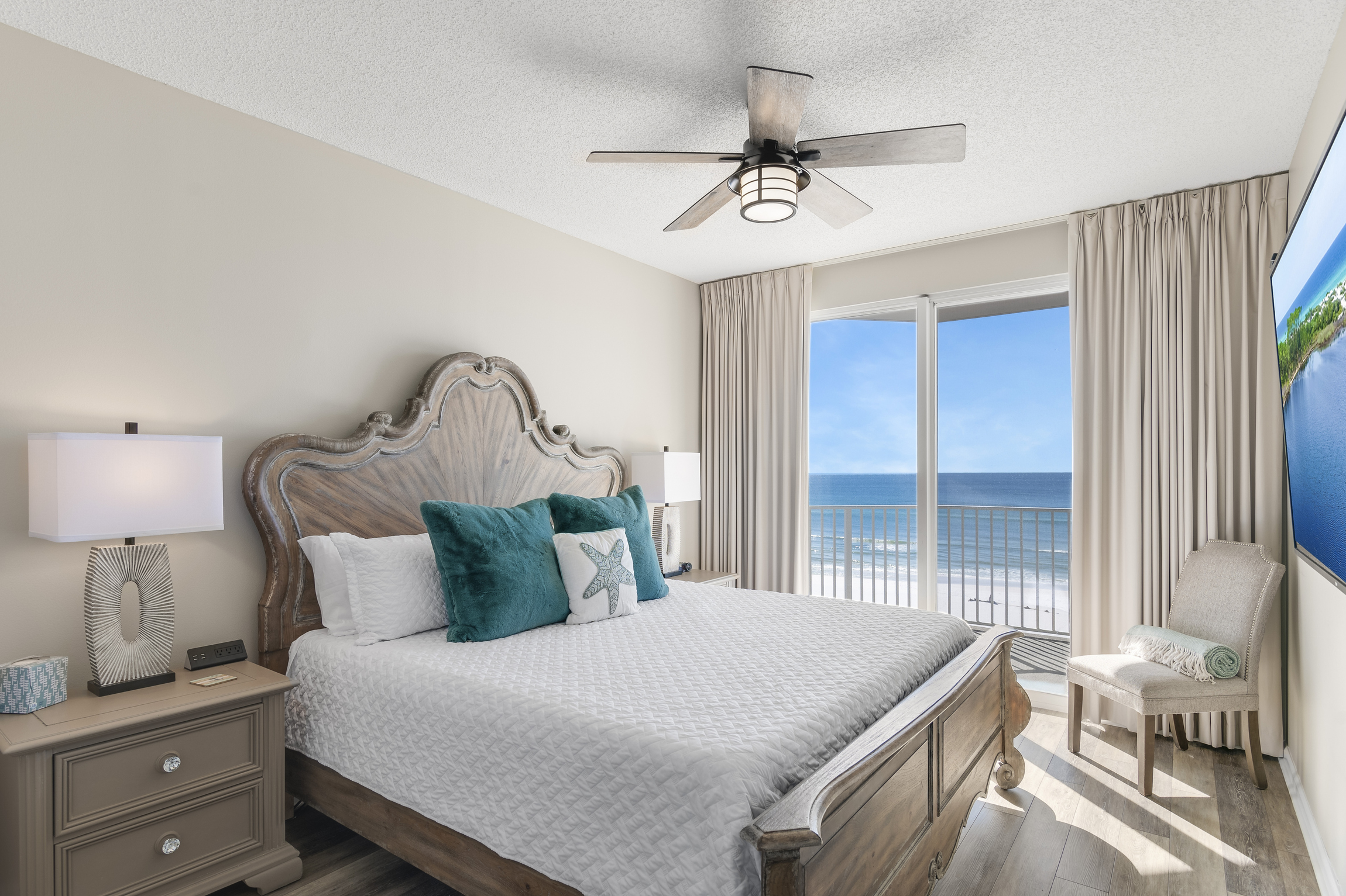 Big Gulf views from the primary bedroom which features a King Bed, new furniture, HUGE 70" Smart TV, large closet, and private bathroom with dual vanity & new countertops