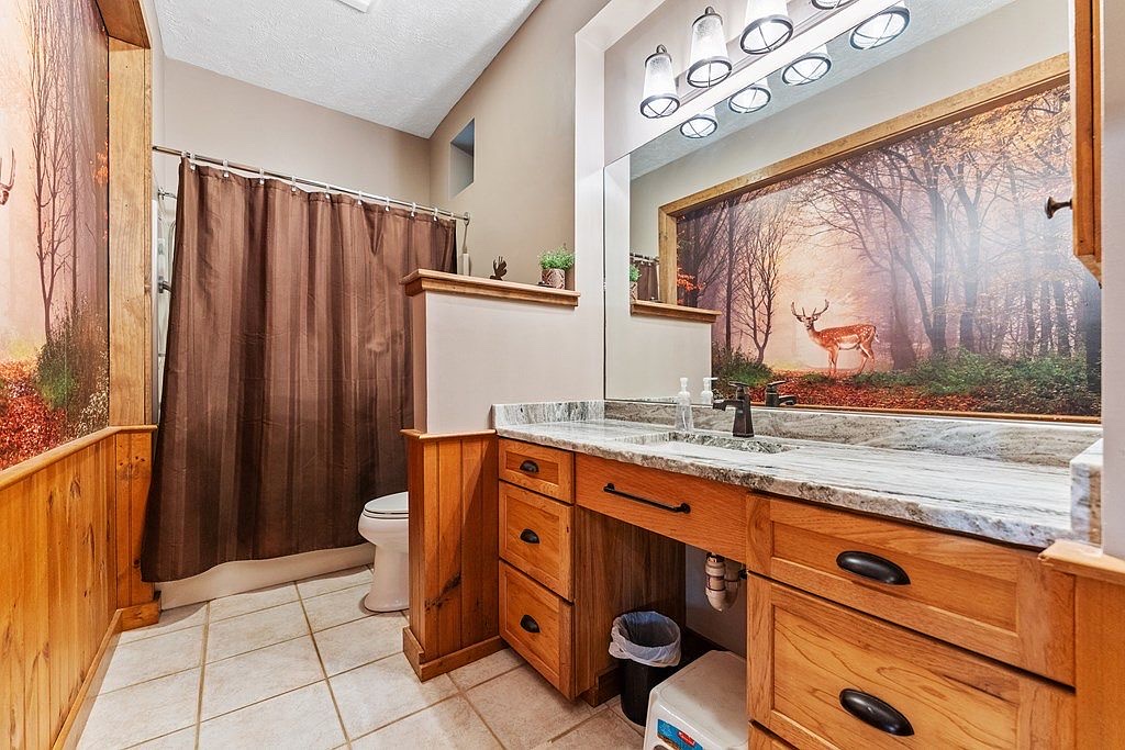 Main level shared full bath w/ tub & shower - stability bars for support