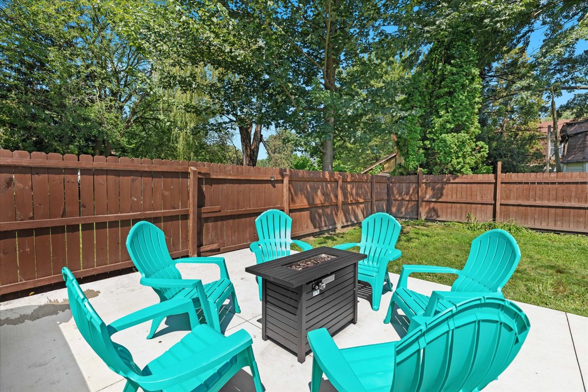 Backyard patio with Adirondack chairs—perfect for morning coffee or evening drinks