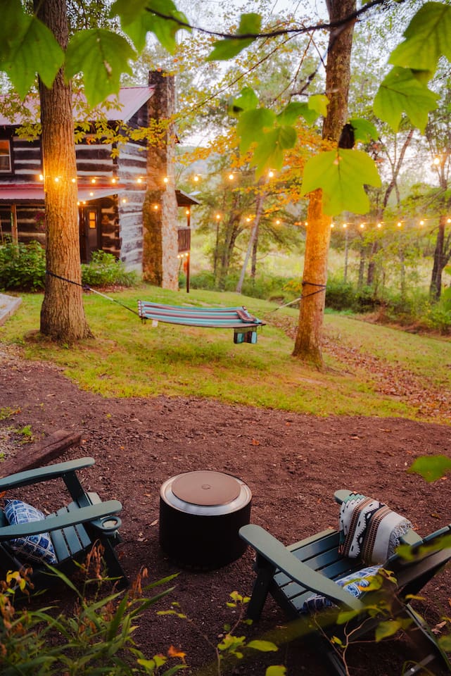 Soak in the peaceful outdoors, with twinkling lights gently illuminating the trees.