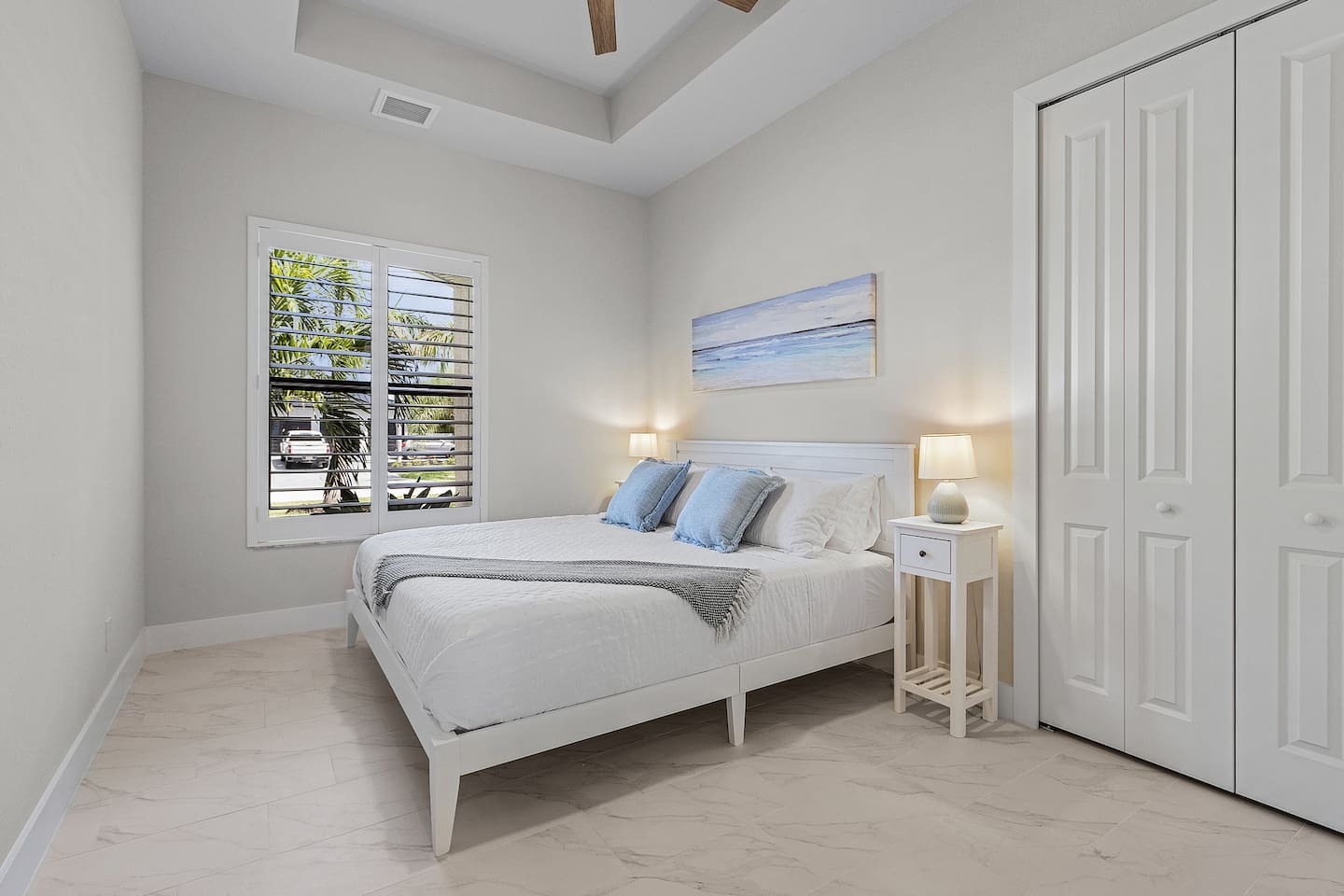 1st Guest bedroom featuring a king-size bed and elegant coastal design, creating a serene retreat for restful nights!