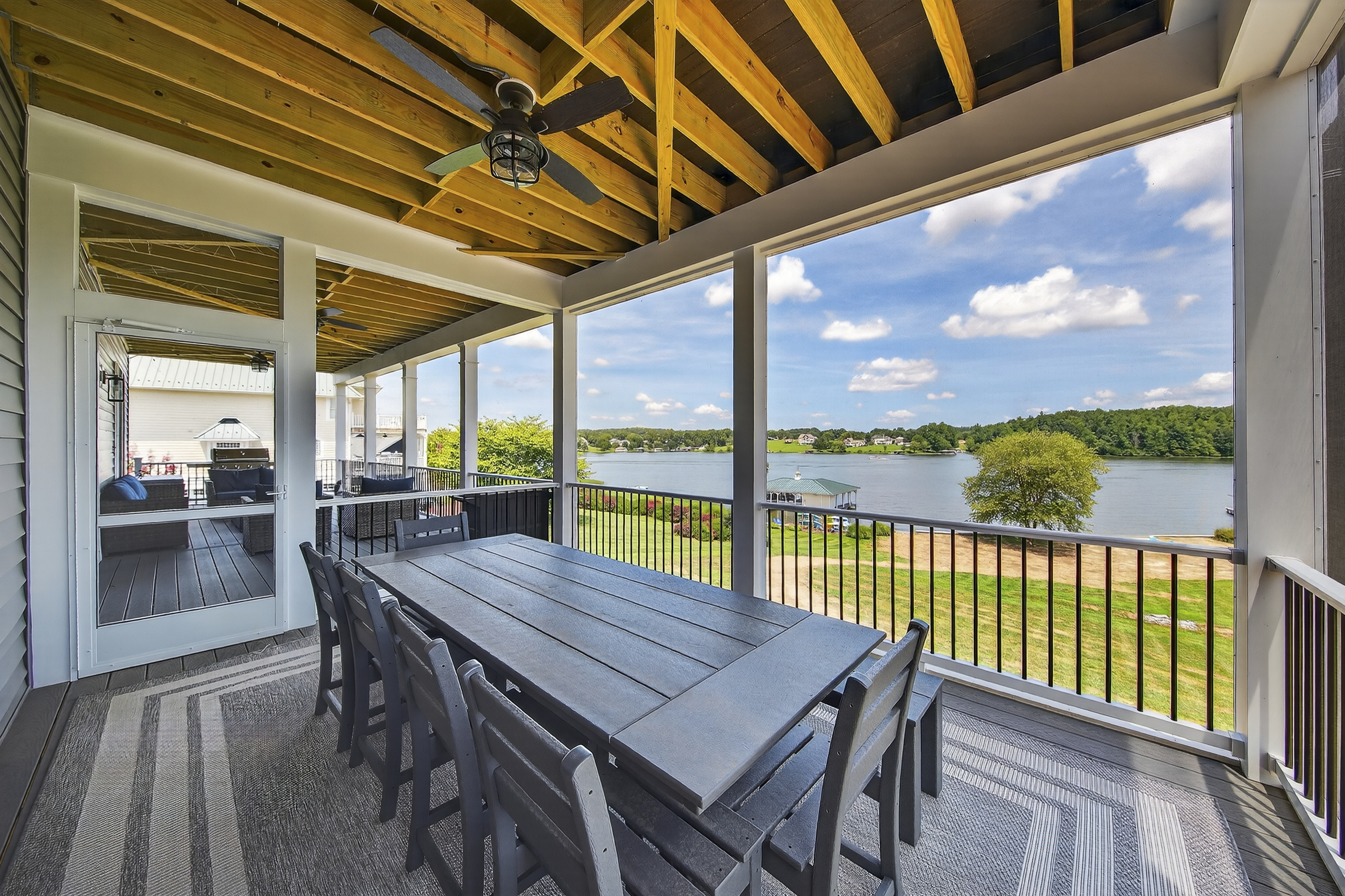 Dine al fresco—screened in, shaded, and steps from the water.