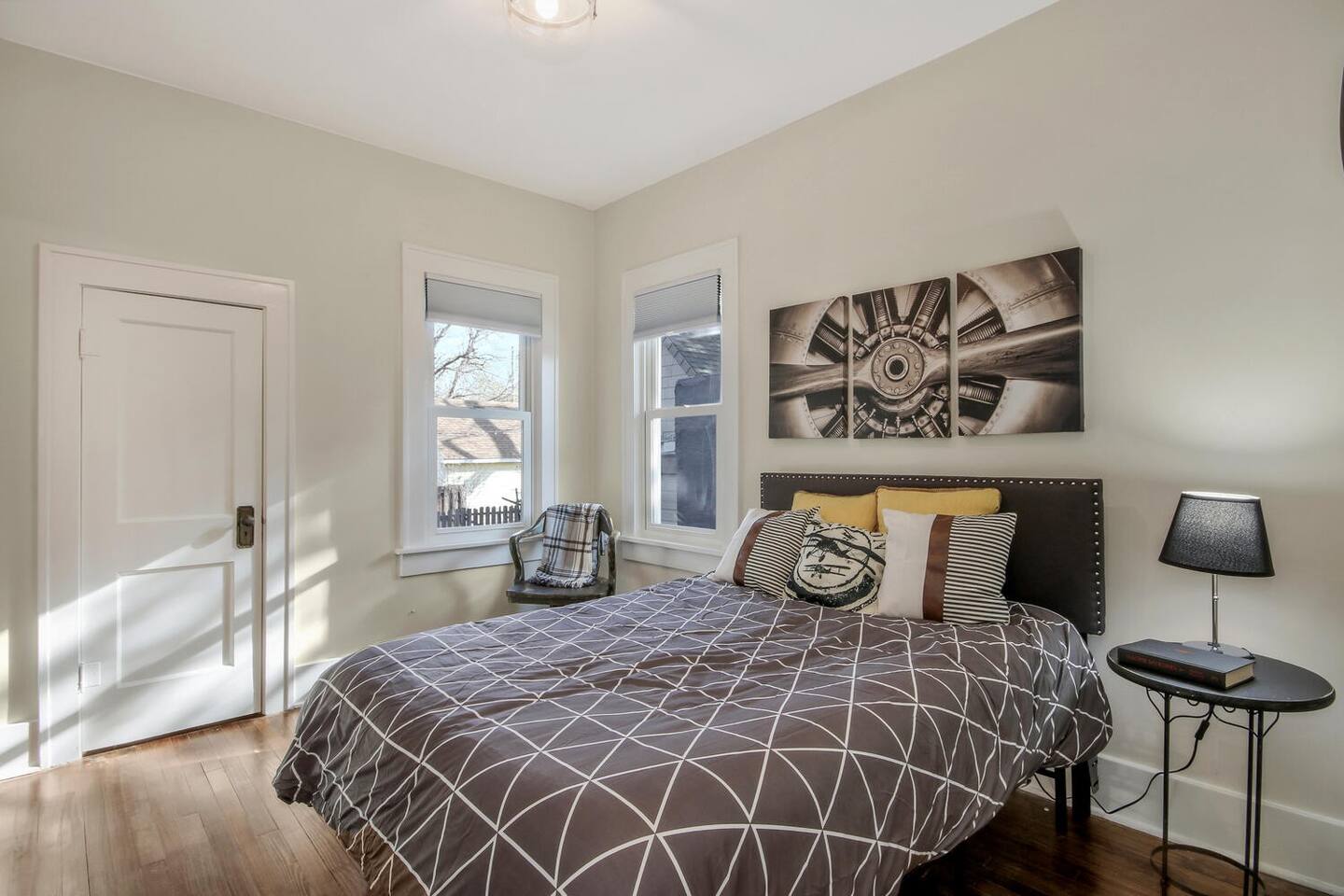 The Aviator room features vintage aviation artwork, a full sized bed, and a USB charging station on the nightstand  lamp.  This room is also adjoined with the sunflower room through barndoors.  It does have a separate entrance in the hall as well. 
