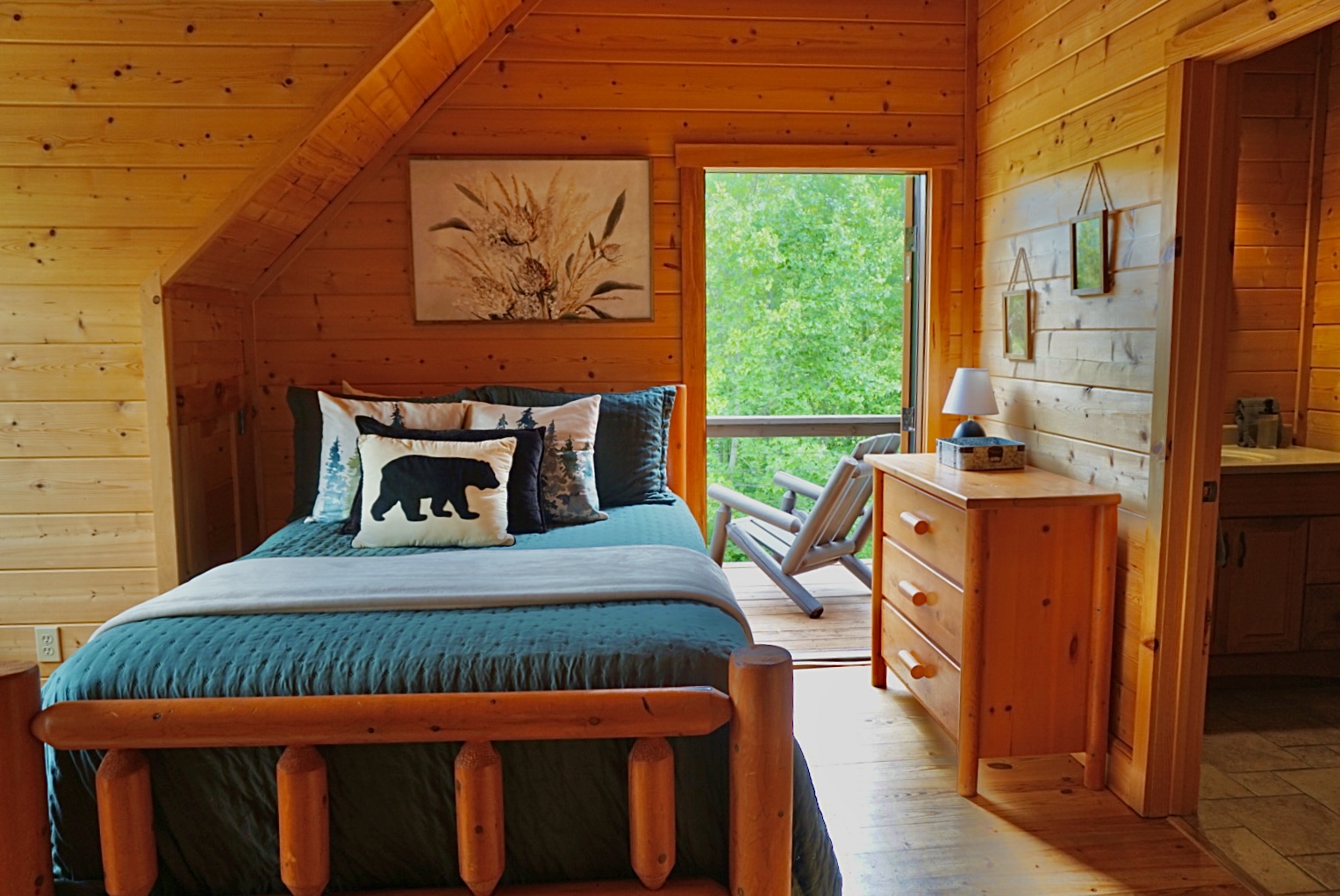 Bedroom Retreat: Inviting space with nature views, comfy bed, and rustic charm awaits your escape!