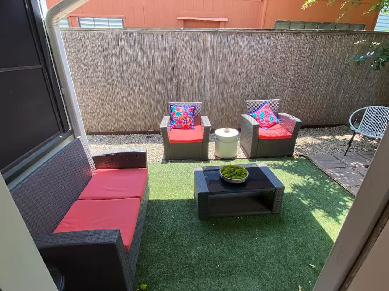 Backyard with patio seating and kid-friendly play space.