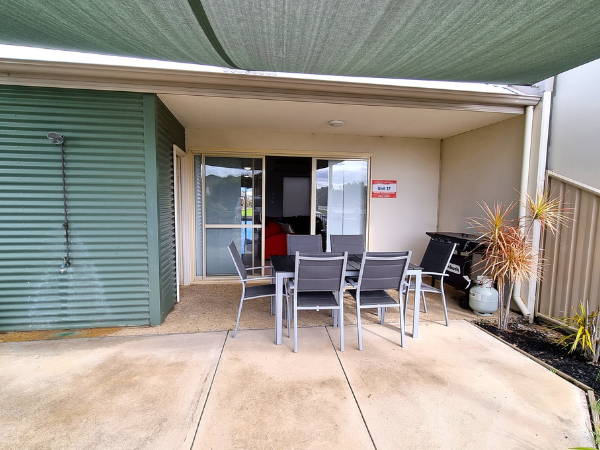 Outdoor dining for 6 people, with large shade sail and includes gas BBQ under main roof (this area faces the street)