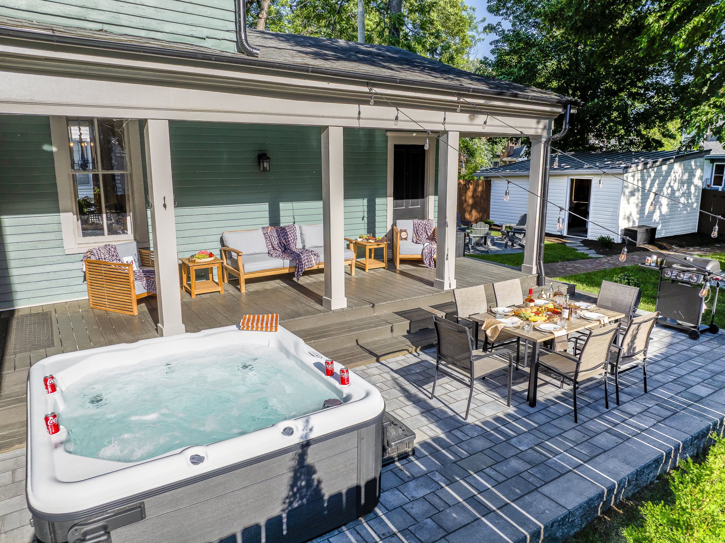Hot tub, covered dining, a fire pit, string lights, and a game lawn come together to create the ultimate backyard retreat.