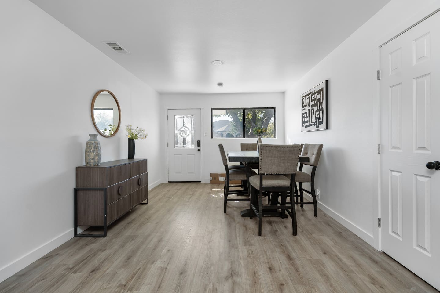 Spacious dining room in the heart of the home. Enjoy meals, game nights, or remote work with a clear view of the living room and kitchen.