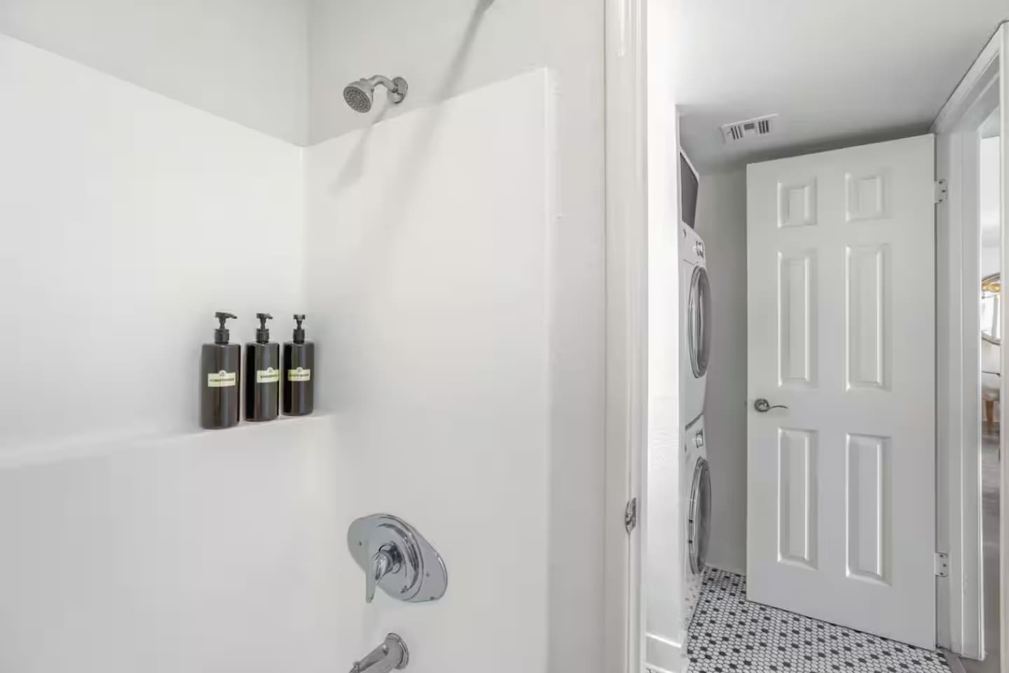 A clean, well-appointed bathroom with an in-unit washer and dryer just steps away — everything you need for an easy stay.