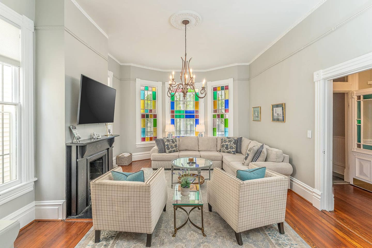 Stain glass windows facing south let in brilliant light throughout the day!  Spacious with double pocket doors leading into the dining room - great for entertaining.  Close the pocket doors, pull out the sofa bed make this living room a 4th bedroom!