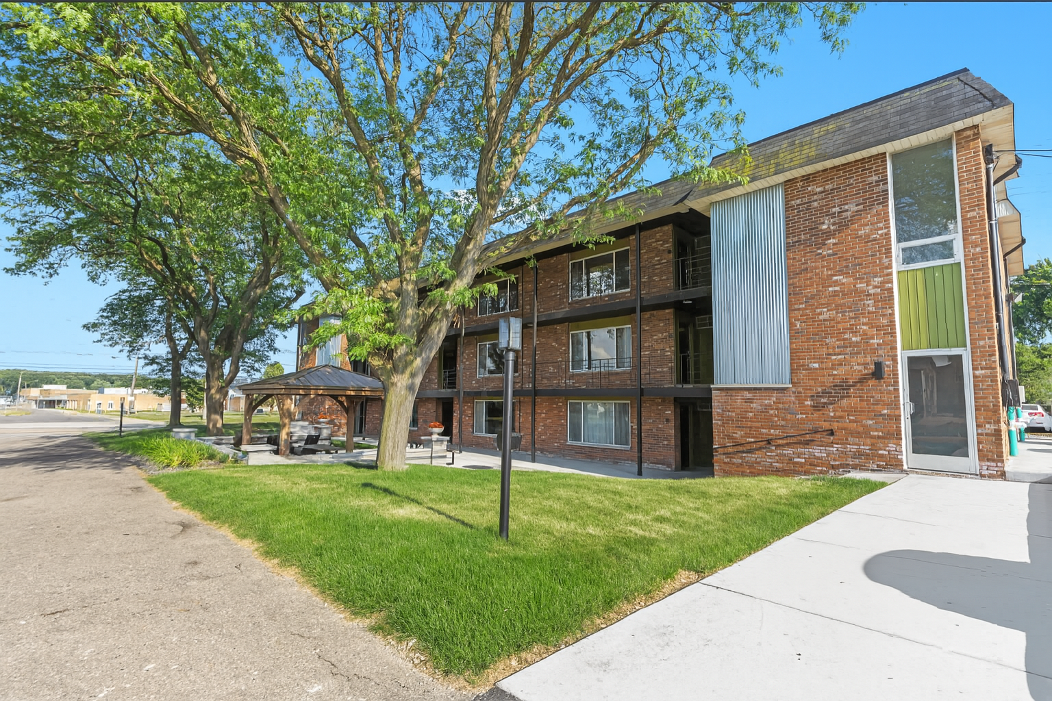 Well-maintained exterior with shaded walkways and ample green space.