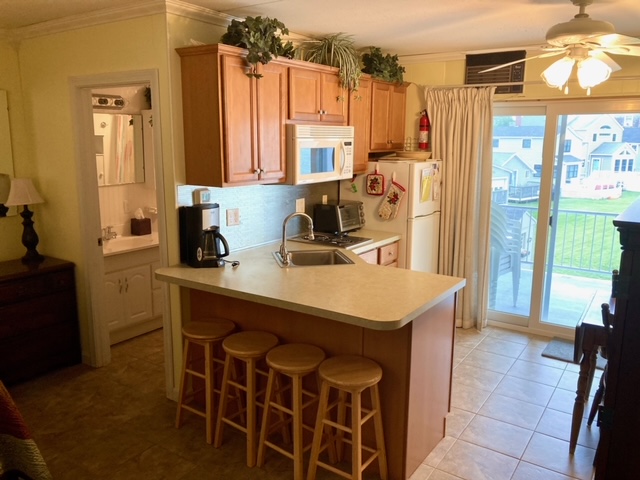 Kitchen is complete with full size fridge, microwave, coffee maker, stove top, and toaster oven