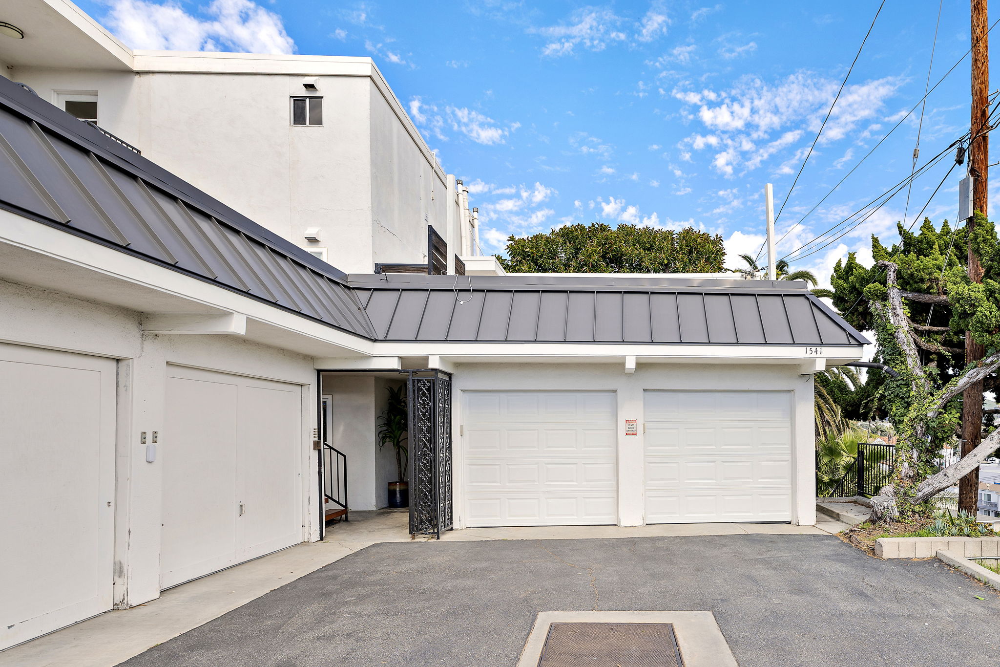 Shared driveway with single-car garage parking (one vehicle only). The second bay is dedicated to bikes, beach gear, and ping-pong. Garage fits a Toyota 4Runner or smaller. Free street parking is also available approximately 500 yards away
