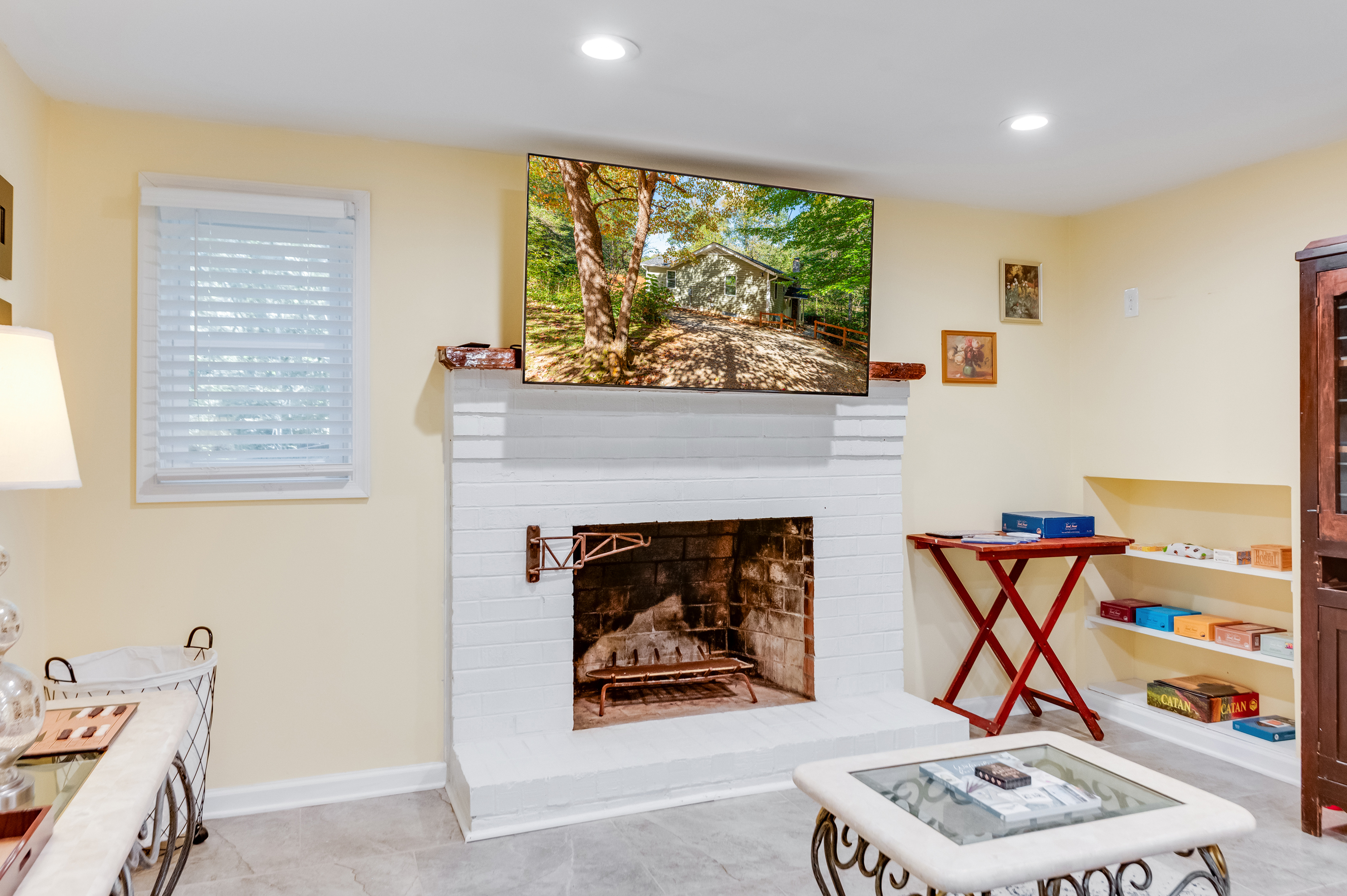 Downstairs Living Room: Relax by the fireplace with board games and views of nature!