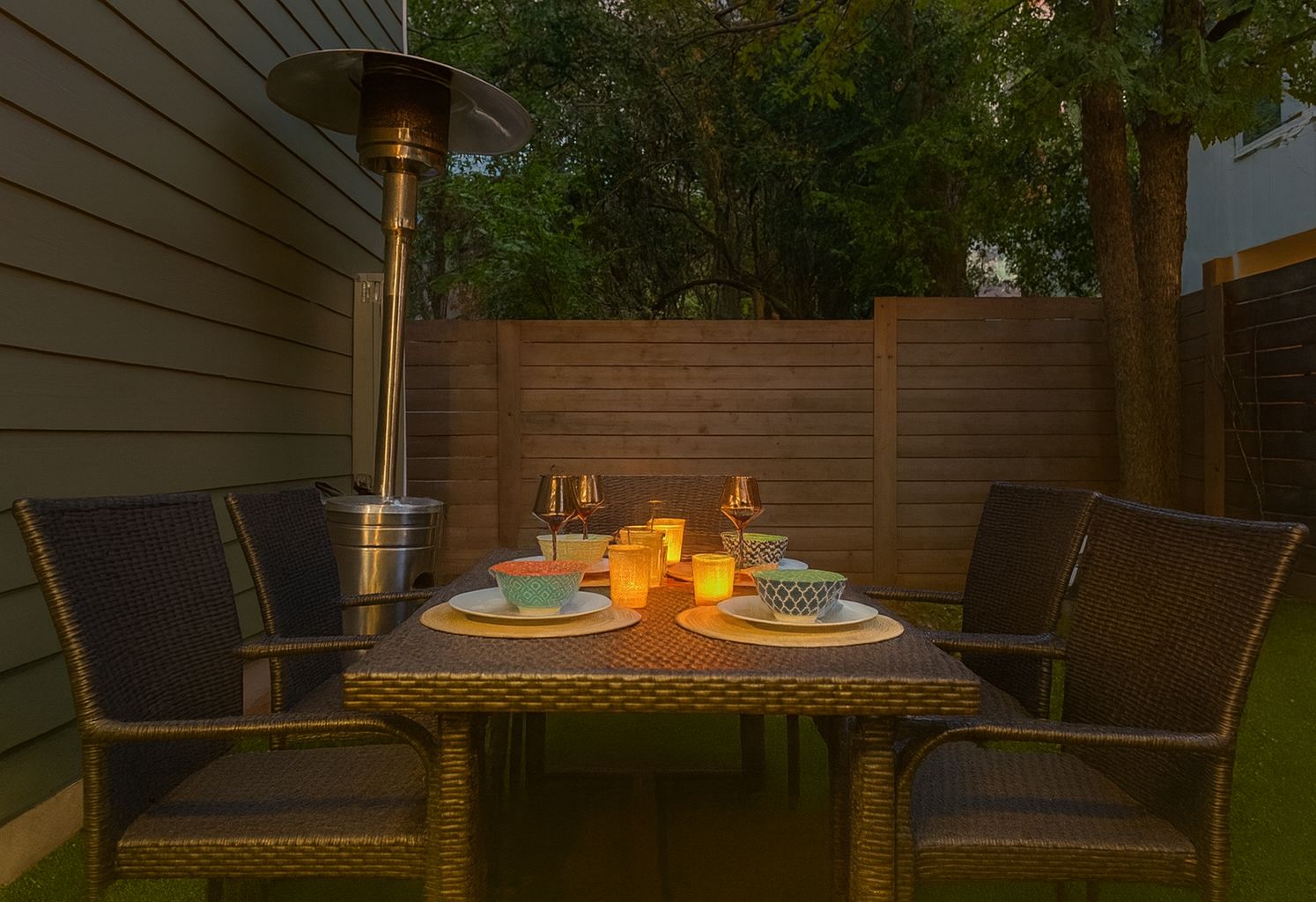 outdoor dining at turf grass yard, with gas lamp heater, warm and cozy even in winter