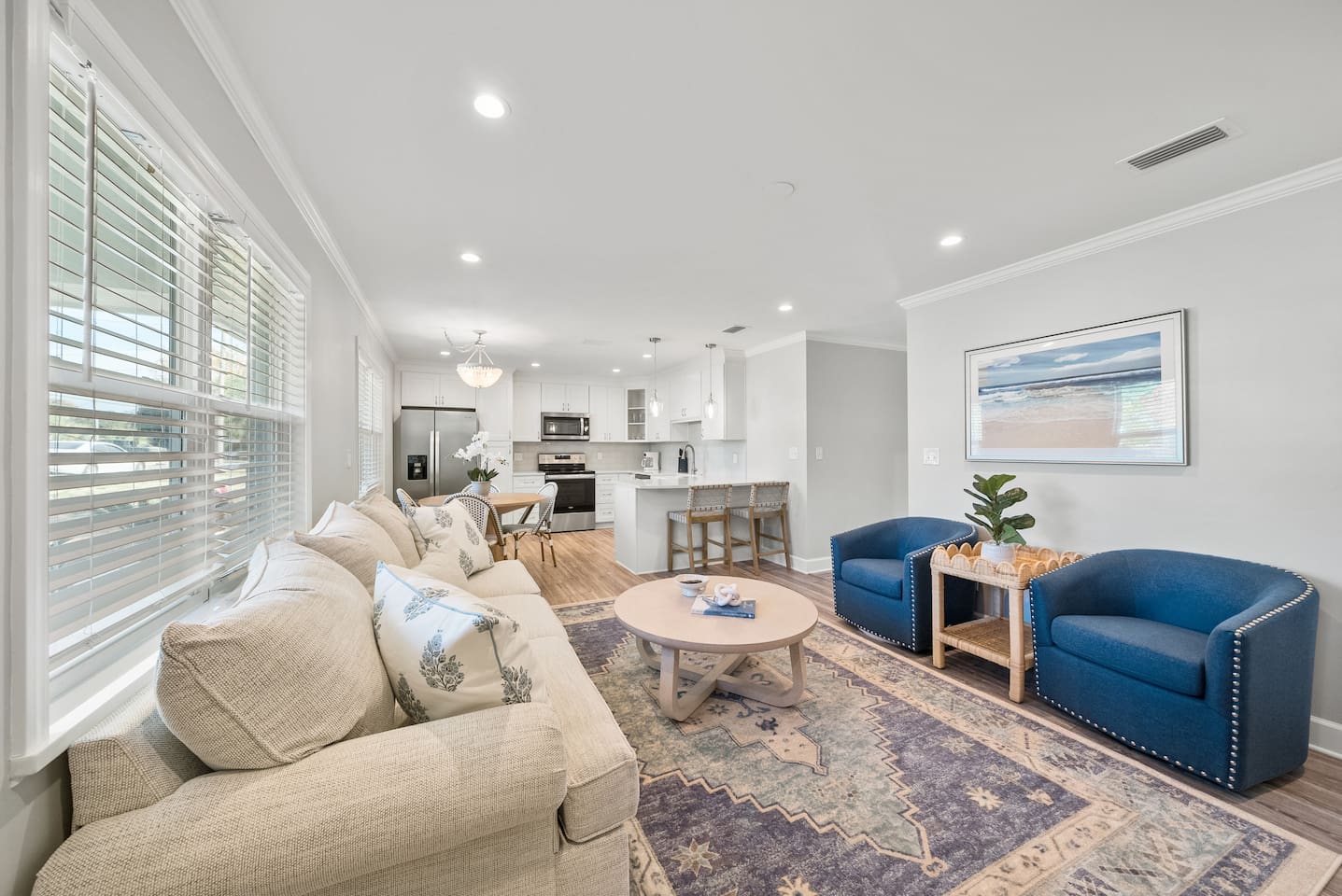Living room of Unit A. Featuring a sleeper sofa, open concept to the kitchen and a smart TV.