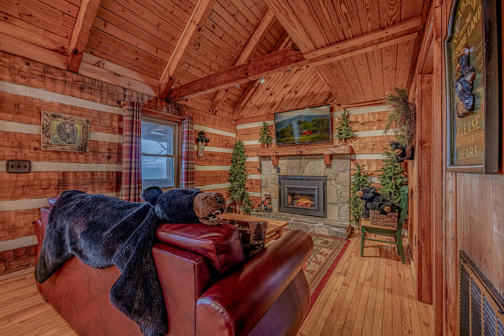 Unwind by the fireplace in this warm and inviting log cabin living room.
