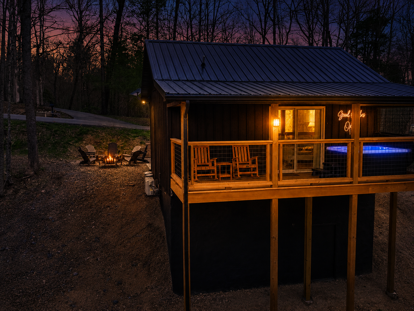 Back deck faces woods, enjoy the hot tub and rocking chairs as you unwind