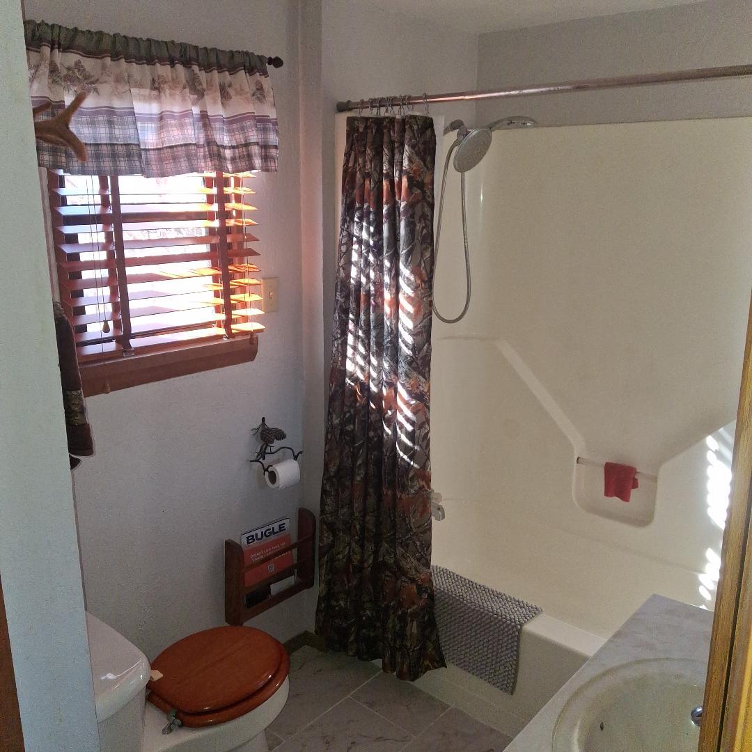 Bathroom with bathtub downstairs.