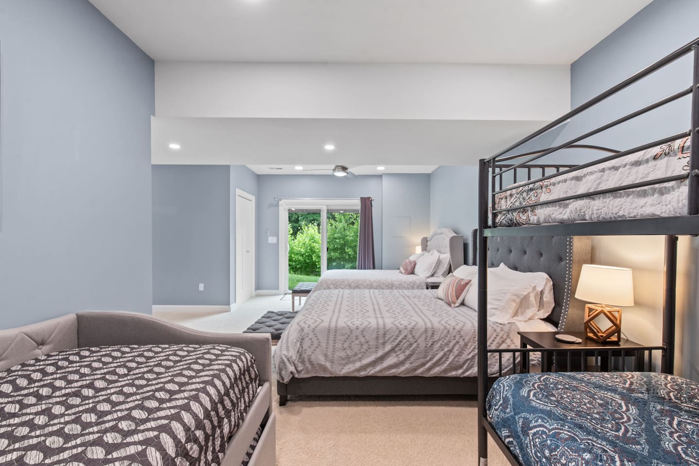 There are sliding glass doors that go out to the backyard. Blinds are built into the doors, and there are blackout curtains to ensure a restful night. 