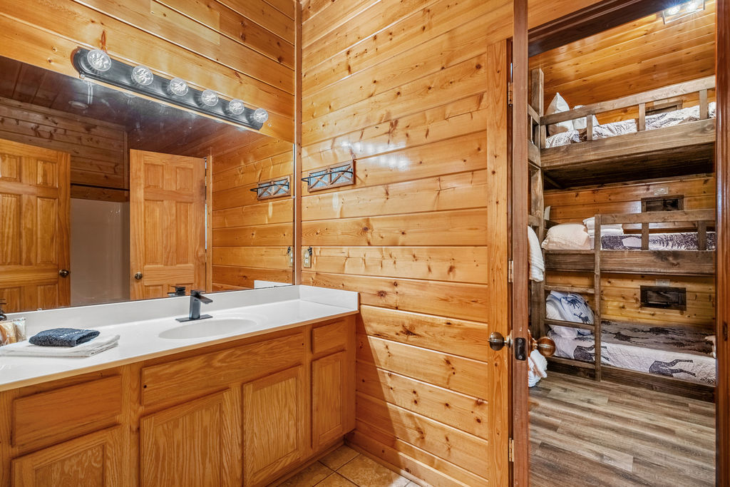 Enjoy the privacy and convenience of an ensuite bathroom, offering rustic charm and comfort just steps from your cozy mountain retreat.
