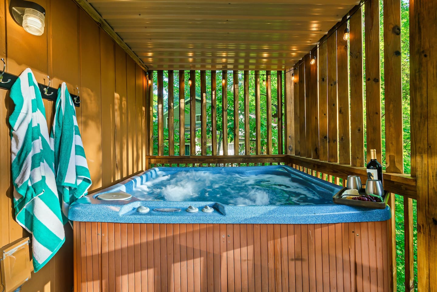 Unwind in the private hot tub, on the main level covered porch
