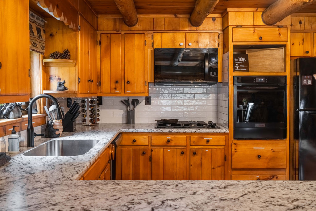 Gather for meals in our spacious kitchen and dining area—plenty of room for the whole crew with seating for 8 and a view of the woods through every window.