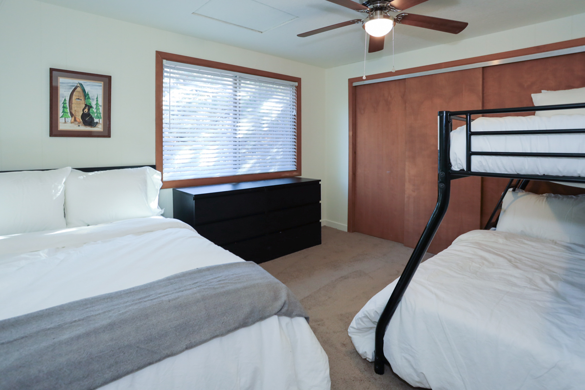 Bedroom 2 has a cozy double bed and a bunk bed with double/twin combo. Ceiling fan.