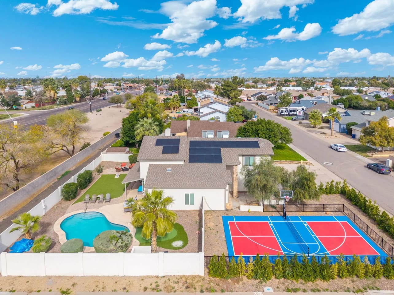 Luxury estate with resort pool, sports courts, solar panels, and sprawling grounds—the ultimate group retreat.