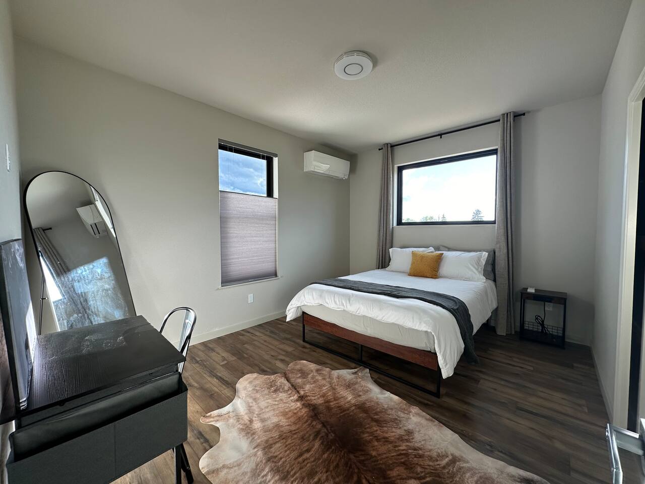 Sleep well one of the two spacious bedrooms.  Each had a walk-in closet, queen bed, luxury linens, full length mirror, own mini-split and bathroom.   The gorgeous picture windows have blackout curtains for night.  This room has a work station.  