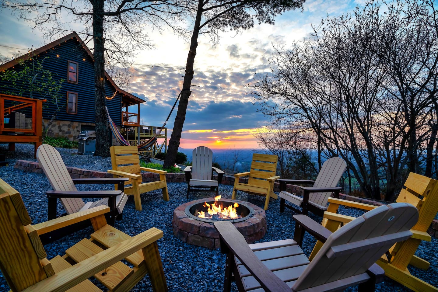 Charming outdoor firepit area offering stunning sunset vistas and a cozy space for roasting marshmallows, family gatherings, or romantic evenings - perfect for evening relaxation and memorable outdoor moments.