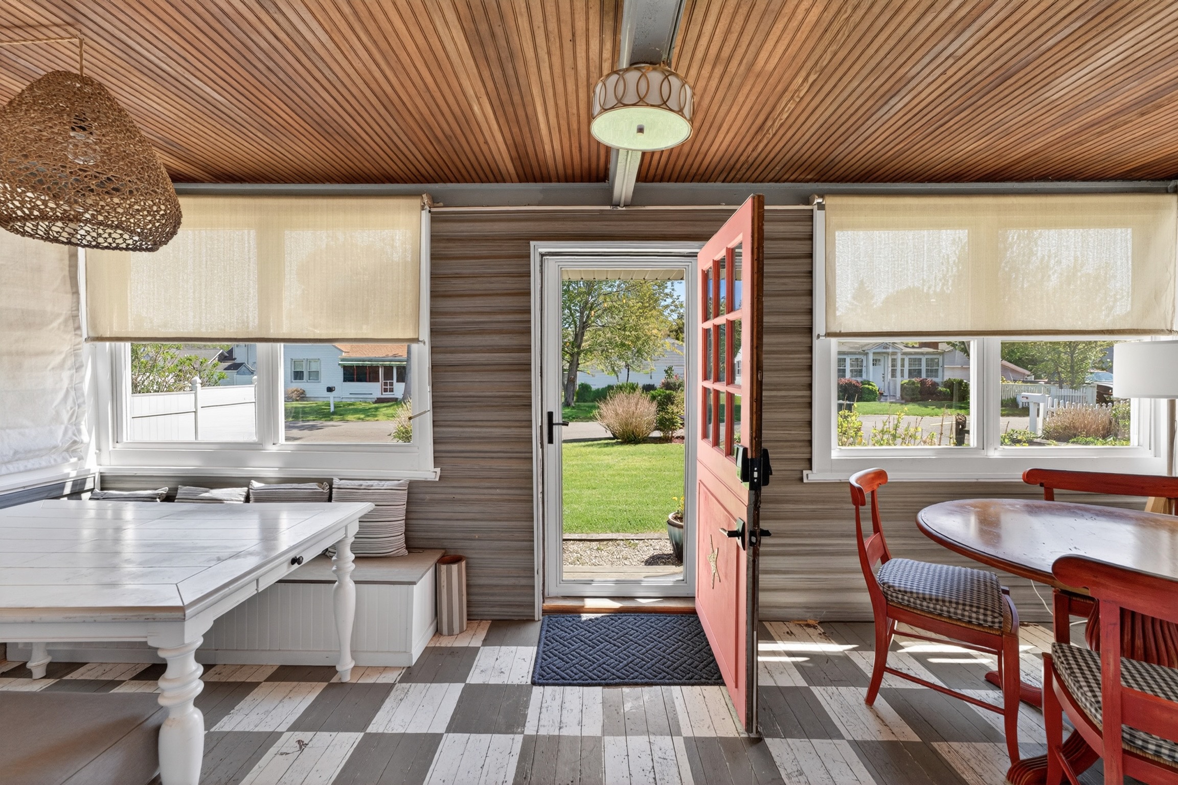 Step into this coastal cottage and you’ll find a welcoming game table and a spacious living room perfect for gathering and relaxing.