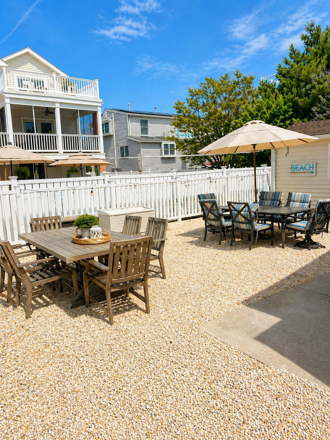Spacious backyard featuring plenty of outdoor furniture, a hammock, gas grill, clothesline, and outdoor showers.