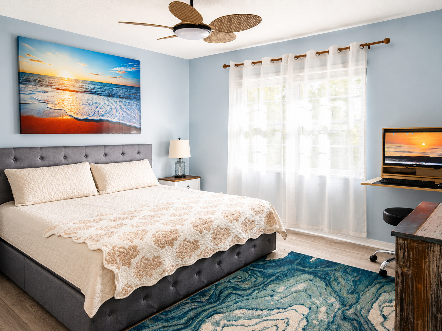 Serene coastal bedroom with tufted headboard, sunset art, and ocean‑inspired décor.
