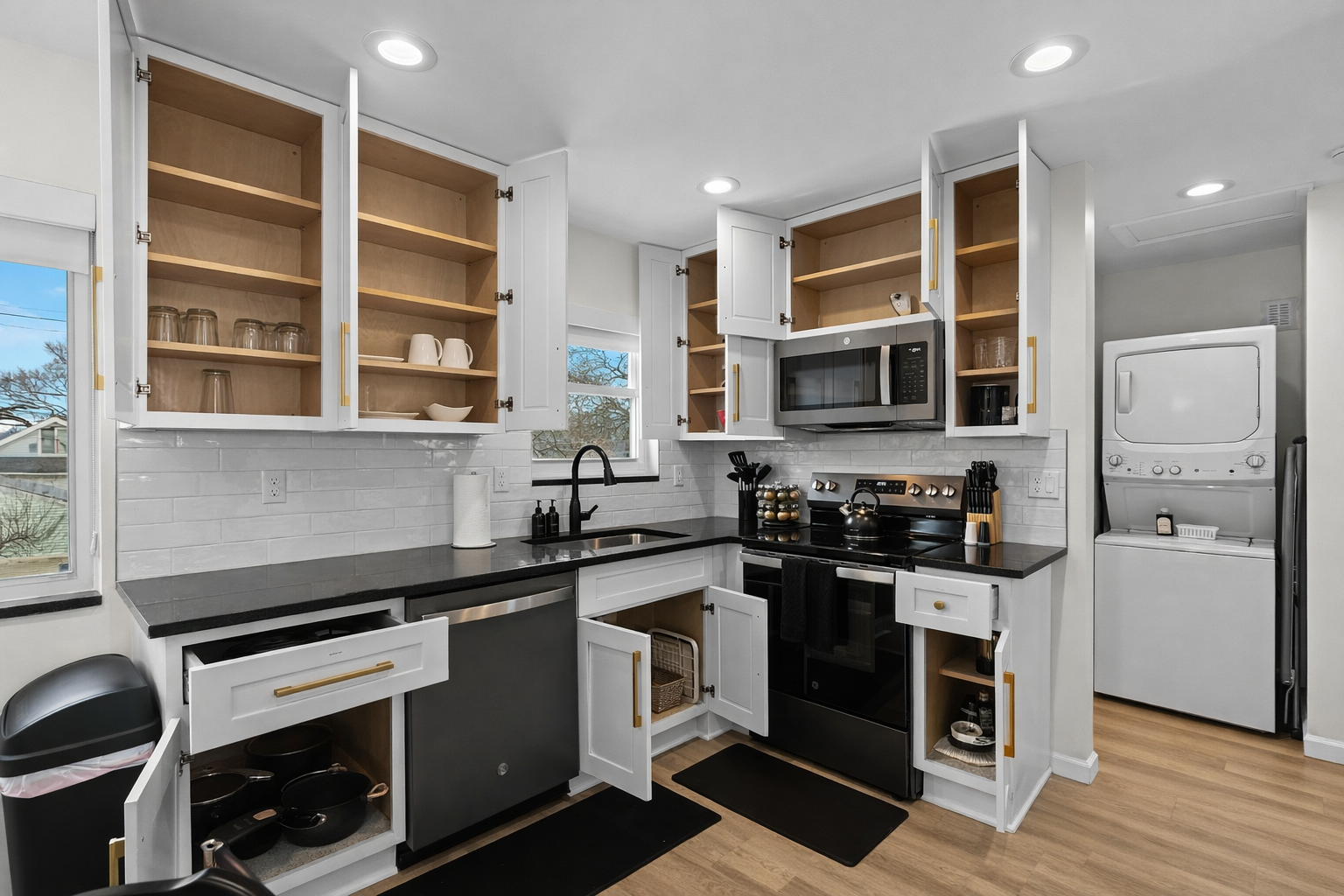 Modern, fully equipped kitchen with ample storage, sleek finishes, and in-unit laundry—perfect for cooking, prepping, and extended stays.