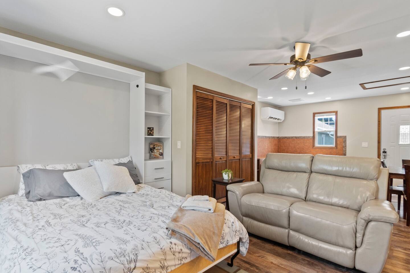 Queen-sized bedroom with a cozy couch and direct access to the living area, providing a seamless flow and extra comfort.