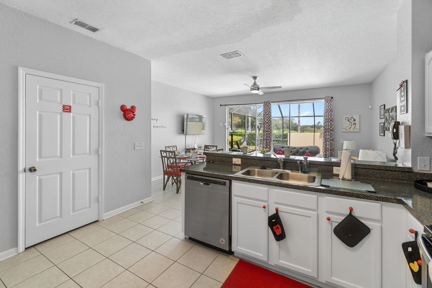 - Open kitchen with double sink, modern appliances, and plenty of counter space  
- Overlooks bright living and dining area with direct patio access outside  
- Functional and inviting space for cooking, gathering, and enjoying meals together 