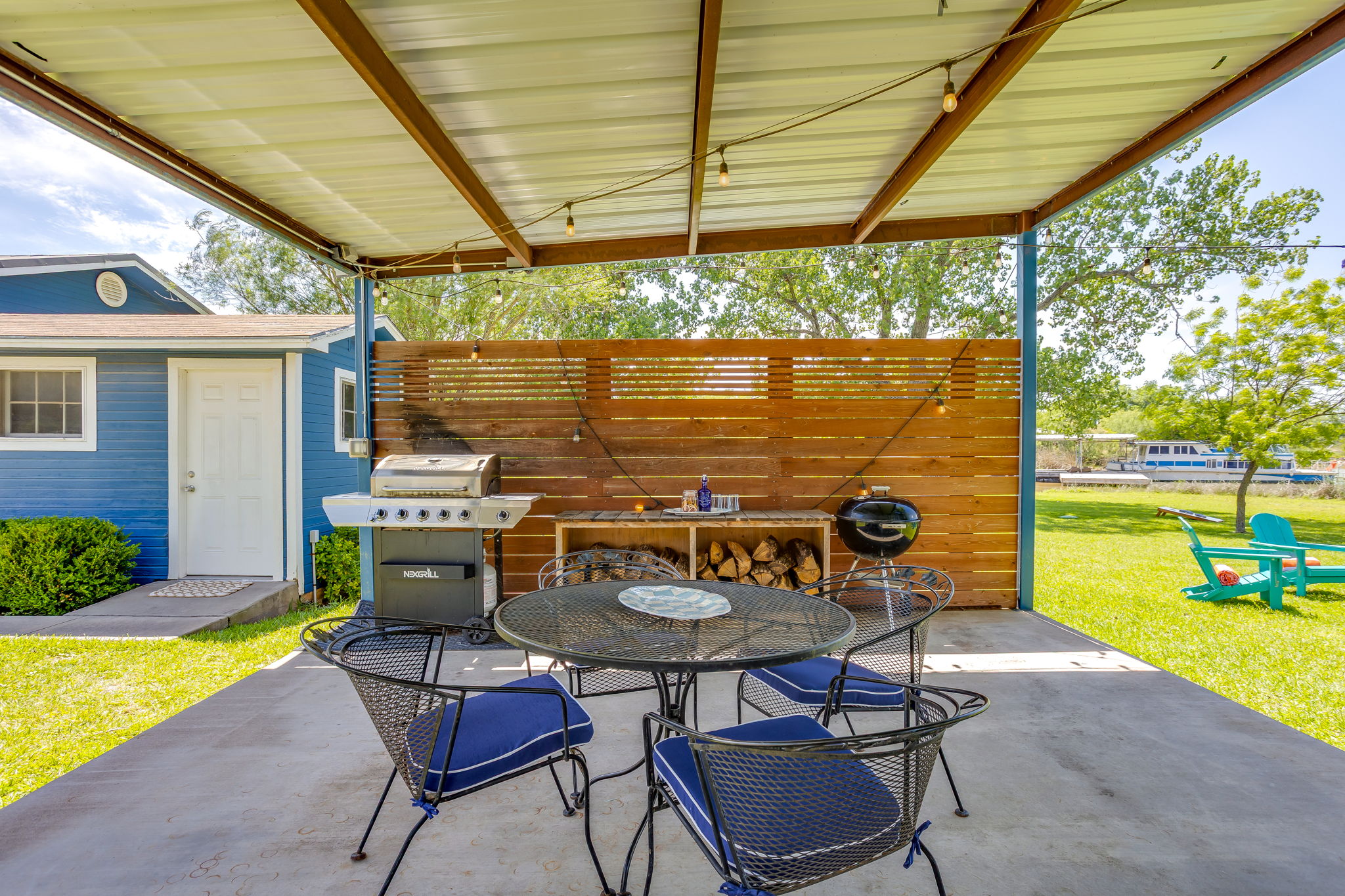 Outdoor covered patio with gas grill, charcoal grill and lots of seating