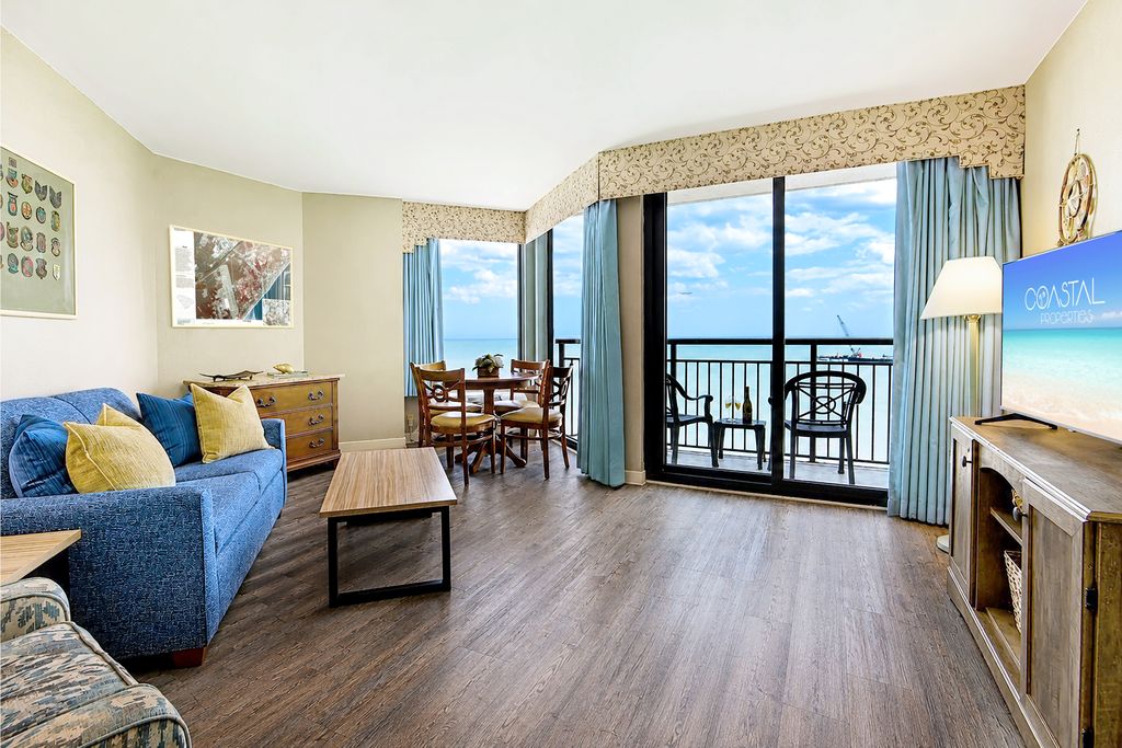 Find serenity in the living area of our oceanfront suite, where thoughtfully arranged furnishings create a tranquil space to relax by the sea.