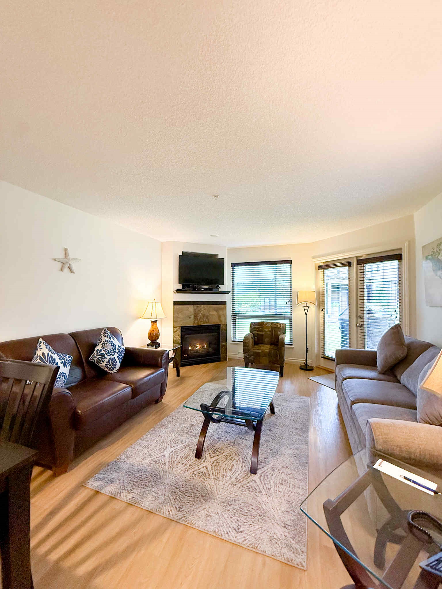 Unit A Living room area. Natural gas fireplace. Streaming TV. Double glass doors to private covered patio.