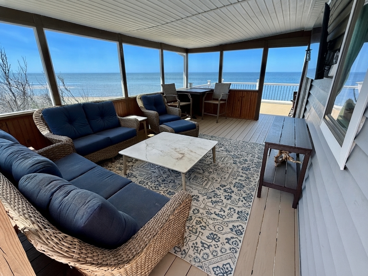 Unwind in this elegant screened-in porch, the ultimate luxury relaxation space. Featuring comfortable wicker seating and panoramic ocean views, it is the perfect spot to enjoy the coastal breeze in total comfort.