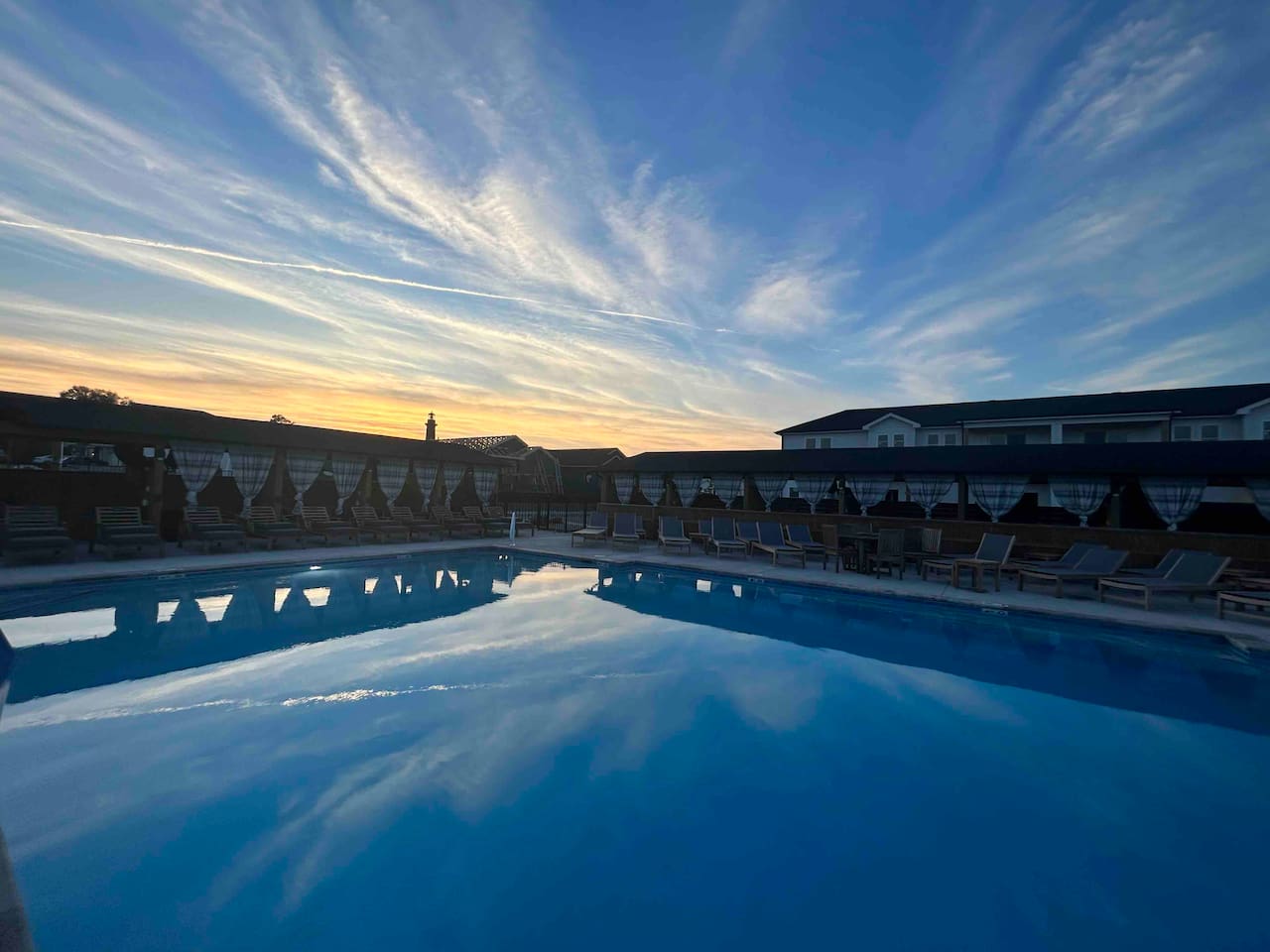Pool has private cabanas for rent with misting fans, couch, TV and mini fridge.  