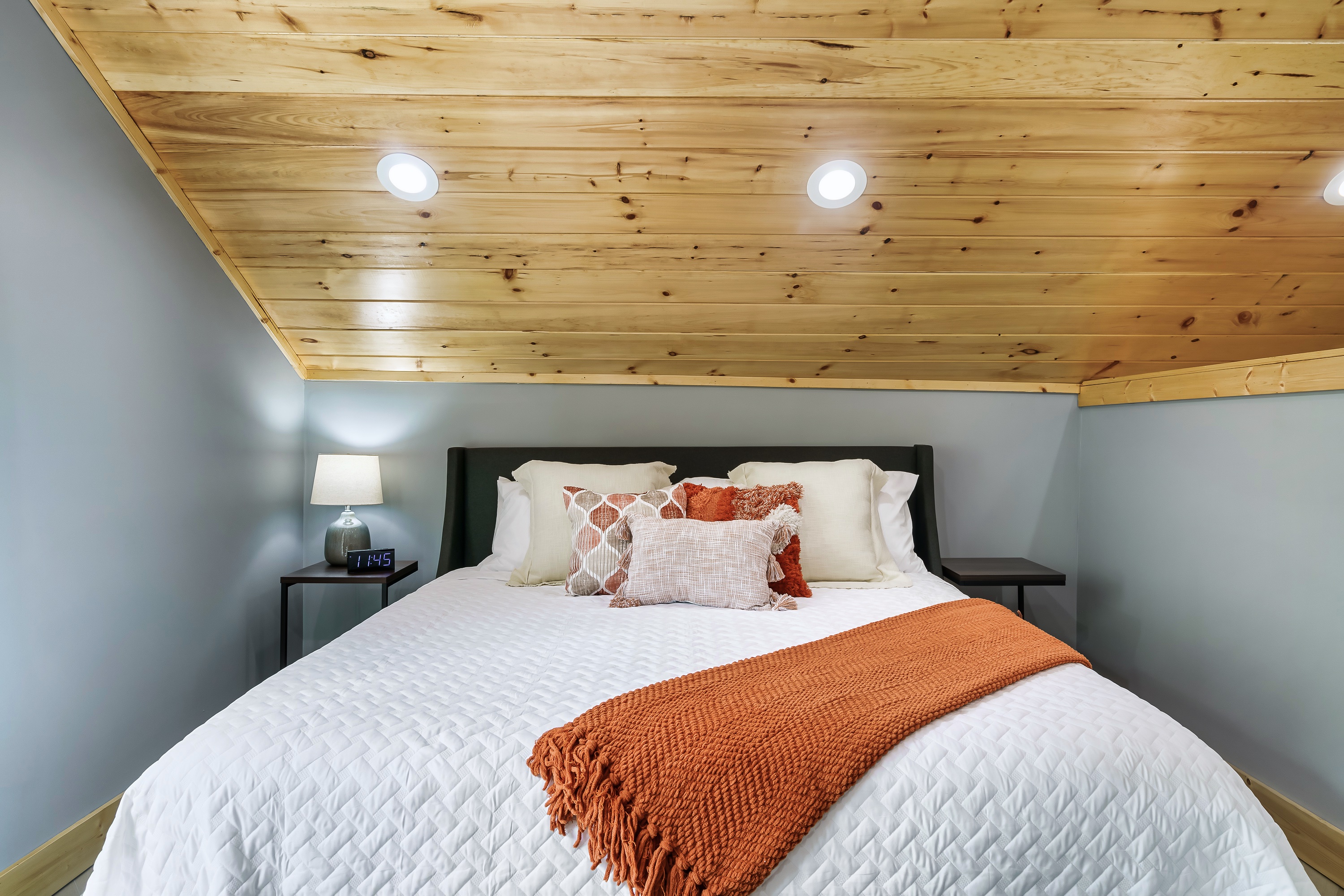 Sleep soundly in this spacious king bed. (Don't forget to charge your phone using our USB compatible clock.)